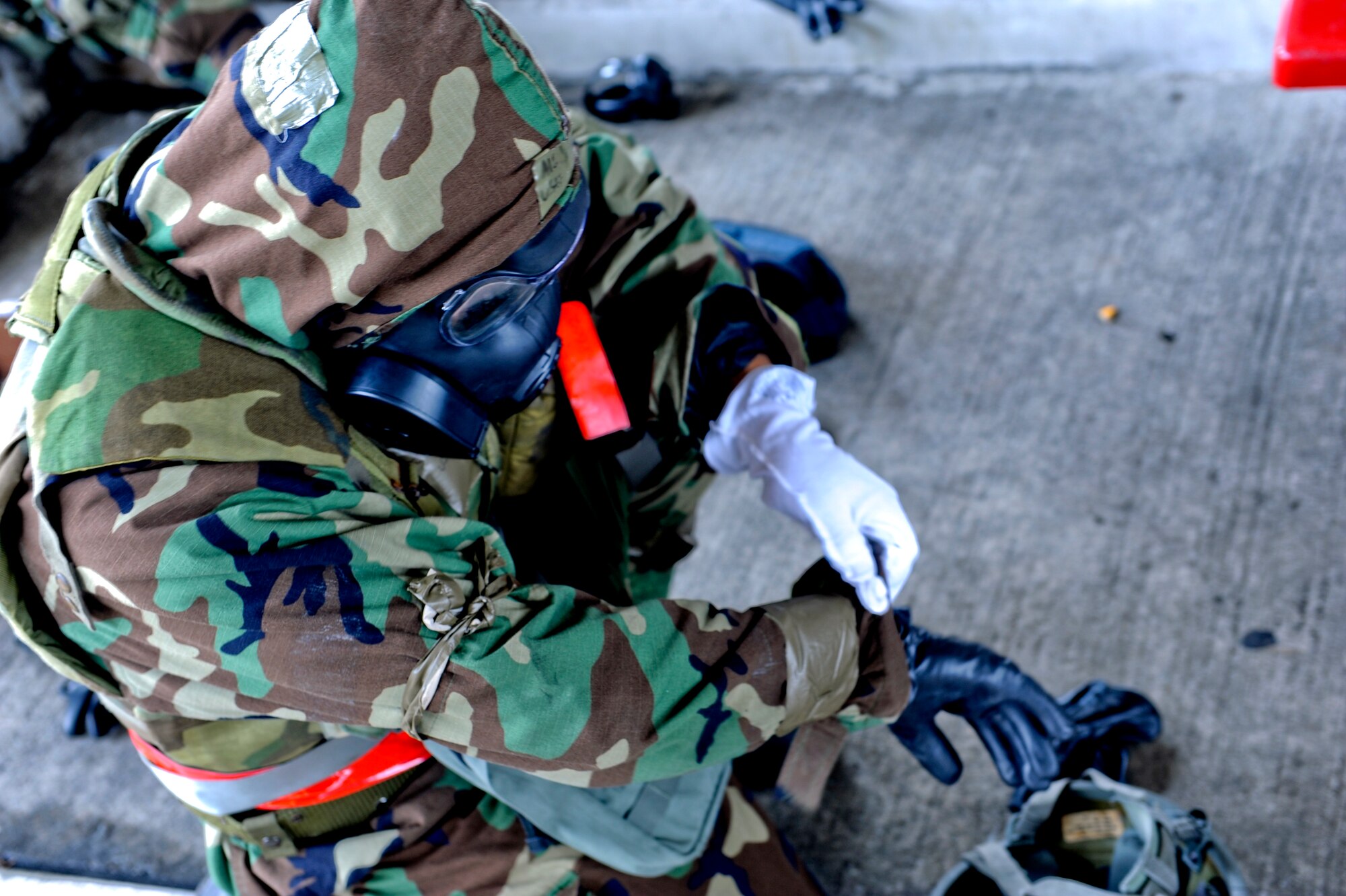 U.S. Air Force Airman 1st Class Jared Smelley, 18th Aircraft Maintenance Squadron crew chief, puts his gear on in a simulated attack during Beverly High 12-5, a local operational readiness exercise on Kadena Air Base, Japan, Aug. 24, 2012.  LOREs give Airmen a good opportunity to practice readiness skills and prepare for real world contingencies. (U.S. Air Force photo/Airman 1st Class Justin Veazie)