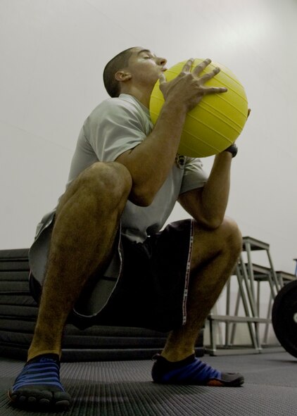 U.S. Air Force Staff Sgt. Joshua Alverez, 7th Force Support Squadron, picks up a 60-pound medicine ball in the new Functional Fitness room Aug. 23, 2012, at Dyess Air Force Base, Texas. The new room, Dyess’ second functional fitness area, features approximately $20,000 worth of new equipment including total body exercise equipment, new bumper plates and varying sizes of medicine balls.  Functional fitness is designed around high intensity strength and conditioning exercises, which constantly vary and work on specific functional movements. (U.S. Air Force photo by Airman 1st Class Peter Thompson/ Released)  