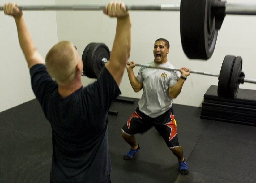 U.S. Air Force Staff Sgt. Dustin McBroom, left, and Staff Sgt. Joshua Alvarez, 7th Force Support Squadron, complete clean and jerks in the new Functional Fitness room Aug. 23, 2012, at Dyess Air Force Base, Texas. The new room, Dyess’ second functional fitness area, features approximately $20,000 worth of new equipment including total body exercise equipment, new bumper plates and varying sizes of medicine balls.  Functional fitness is designed around high intensity strength and conditioning exercises , which constantly vary and work on specific functional movements. (U.S. Air Force photo by Airman 1st Class Peter Thompson/ Released)