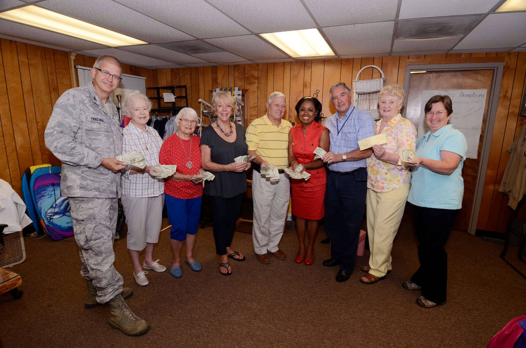 Col. Tim Tarchick, 94th Airlift Wing commander joins volunteers from the Dobbins Thrift Store, 94th Airlift Wing Safety, and the 94th Logistics Readiness Squadron to present Angela Pedersen, Director of the Airmen Family Readiness section with cash and a check totaling $1,613 Aug. 23. The funds raised from proceeds from the Corn and Sausage Roast held earlier this year and from sales at the thrift store, will be used to provide Airmen with emergency financial assistance.  (U.S. Air Force photo/Don Peek)