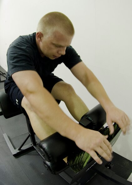 U.S. Air Force Staff Sgt. Dustin McBroom, 7th Force Support Squadron, completes a glute-ham developer sit-up in the new Functional Fitness room Aug. 23, 2012, at Dyess Air Force Base, Texas. The new room, Dyess’ second functional fitness area, features approximately $20,000 worth of new equipment including total body exercise equipment, new bumper plates and varying sizes of medicine balls.  Functional fitness is designed around high intensity strength and conditioning exercises , which constantly vary and work on specific functional movements. (U.S. Air Force photo by Airman 1st Class Peter Thompson/ Released)
