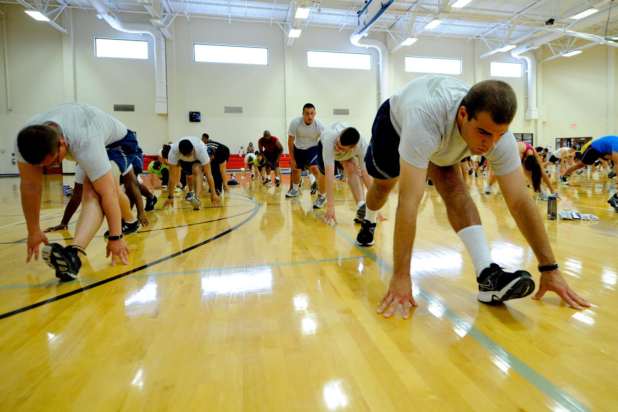 VANDENBERG AIR FORCE BASE, Calif. – Airmen Basic Andrew Vogt, a tech school student (right) stretches with coworkers before a workout with P90X creator, Tony Horton, at the fitness center here Wednesday, August 22, 2012. Horton and his training crew have teamed up with Armed Forces Entertainment for the “Ripped and Ready” tour of American military installations worldwide. (U.S. Air Force photo/ Staff Sgt. Levi Riendeau)