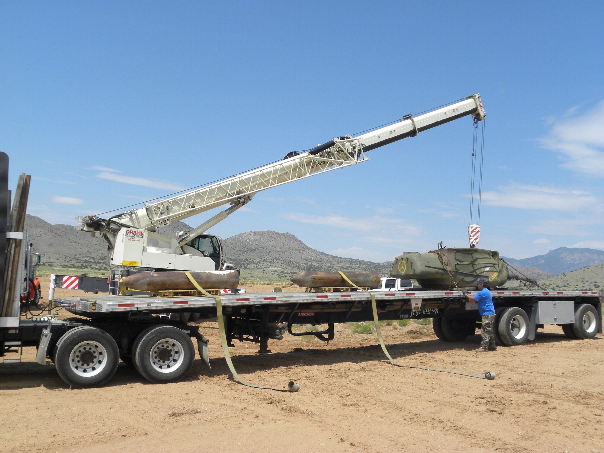 KIRTLAND AFB, N.M. -- A crane removes a tank from the explosive ordnance disposal range at Kirtland Air Force Base. (Courtesy photo)