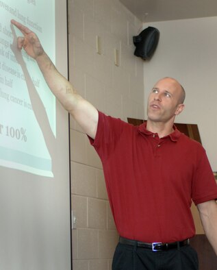 Mark Tschampl, 366th Medical Group director of the Health and Wellness Center, helps Gunfighters overcome a powerful addiction as he explains a slide during his tobacco cessation class, Aug. 22, 2012, at Mountain Home Air Force Base, Idaho. His class boasts the second highest quit rate in the Air Force, the highest in Air Combat Command and a 99 percent participation satisfaction rate. (U.S. Air Force photo/Airman 1st Class Shane M. Phipps)