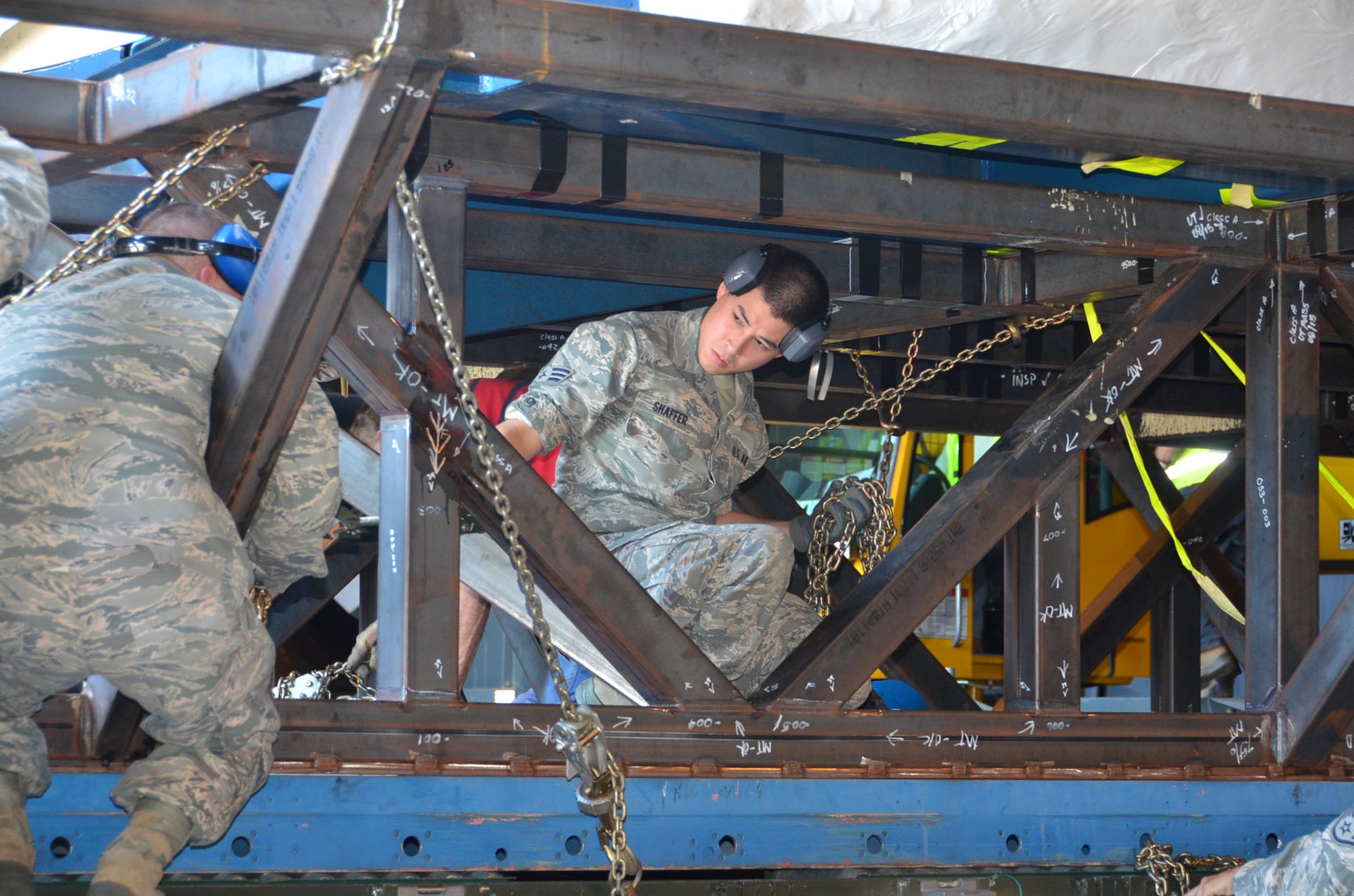 WRIGHT-PATTERSON AIR FORCE BASE, Ohio - Senior Airman Kevin Shaffer, 87th Aerial Port Squadron air transportation journeyman, along with 11 other 87 APS Airmen, NASA loadmasters and National Museum of the United States Air Force restoration specialists, unload the first Shuttle Crew Compartment Trainer from an 87th APS 60K loader into the museum’s Cold War Gallery Aug. 23. The interior will be reassembled here then put on display for the general public when it is moved to a new Space Gallery in the museum’s planned fourth building (U.S. Air Force photo/Lt. Col. Cynthia Harris)