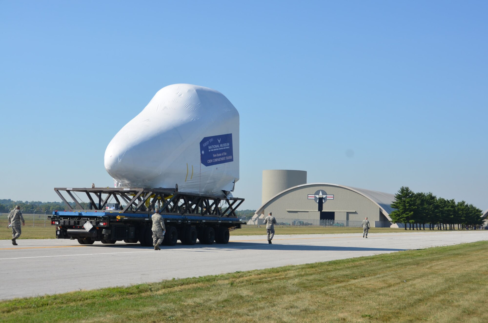 WRIGHT-PATTERSON AIR FORCE BASE, Ohio –Twelve Airmen from the 87th Aerial Port Squadron transport the first Shuttle Crew Compartment Trainer from NASA’s Super Guppy aircraft to the National Museum of the United States Air Force Aug. 23.  The CCT-1 was moved from the Super Guppy to the museum’s Cold War Gallery where its interior will be reassembled then put on display for the general public when it is moved to a new Space Gallery in the museum’s planned fourth building. (U.S. Air Force photo/Lt. Col. Cynthia Harris)
