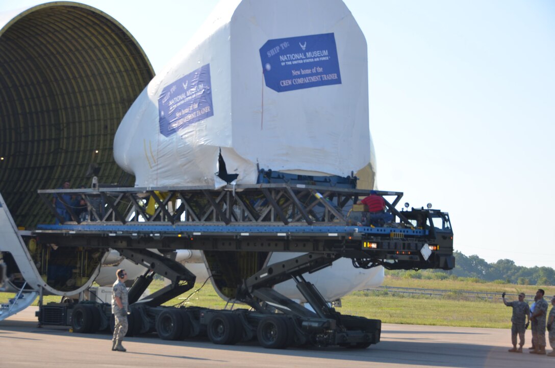 WRIGHT-PATTERSON AIR FORCE BASE, Ohio –Twelve Airmen from the 87th Aerial Port Squadron with the help of NASA loadmasters unload the first Shuttle Crew Compartment Trainer from NASA’s Super Guppy aircraft Aug. 23.  With the help of the National Museum of the United States Air Force restoration specialists, the CCT-1 was moved from the Super Guppy to the museum’s Cold War Gallery where its interior will be reassembled then put on display for the general public when it is moved to a new Space Gallery in the museum’s planned fourth building. (U.S. Air Force photo/Lt. Col. Cynthia Harris)