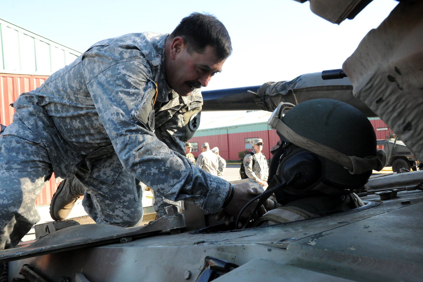 Maj. Gen. Simeon G. Trombitas, the U.S. Army South commanding general, presents a Chilean marine with a commander’s coin Aug. 8 in Fort Aguayo, Chile. (Photo by Eric R. Lucero, U.S. Army South Public Affairs)