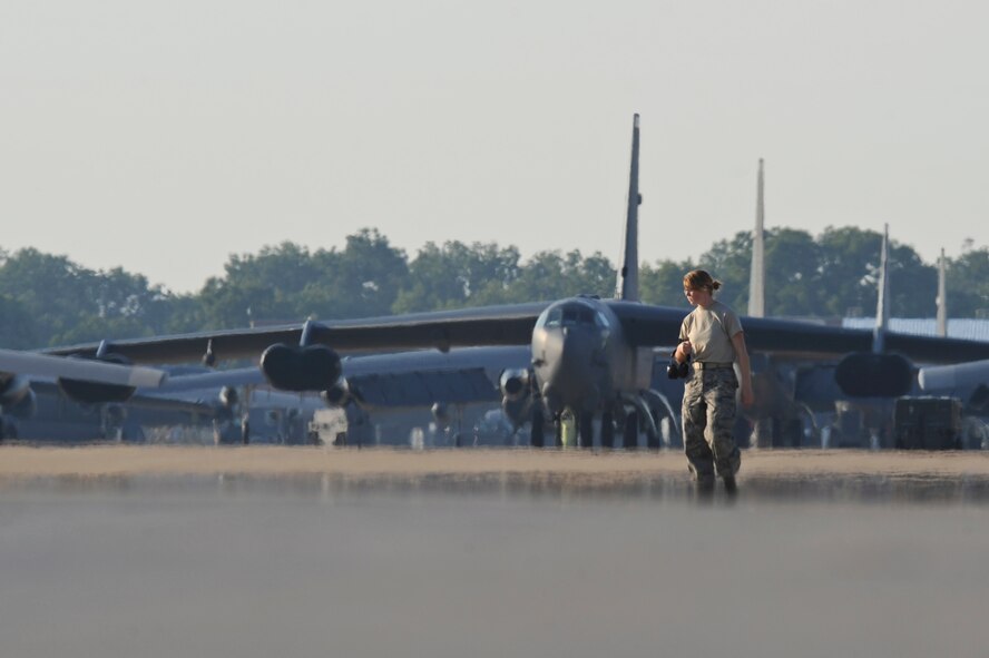 A Barksdale Airman looks for foreign object debris on the flightline on Barksdale Air Force Base, La., Aug. 23. FOD walks are conducted every morning to keep items from damaging aircraft engines. Some examples of FOD are rocks, tools, parts, trash and broken pavement. (U.S. Air Force photo/Airman 1st Class Micaiah Anthony)(RELEASED)