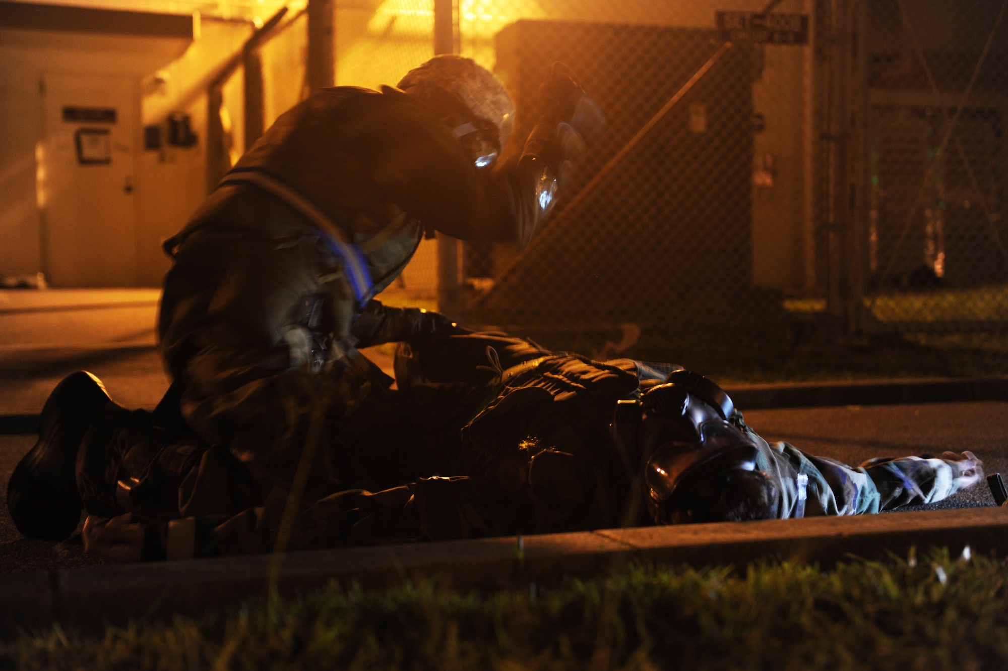 U.S. Air Force Airman 1st Class Jordon Gauthier, 18th Communications Squadron network infrastructure technician, administers antidote injectors to Airman 1st Class Ethen Bradley, 18th Communications Squadron cyber transport technician, during local operational readiness exercise Beverly High 12-5 on Kadena Air Base, Japan, Aug. 24, 2012. The injectors are used to counter chemical nerve agent symptoms in a chemical warfare environment. (U.S. Air Force Airman 1st Class Malia Jenkins/photo)