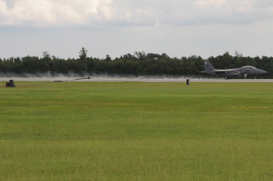 An F-15E Strike Eagle deploys a barrier hook to a pendant cable during a cable engagement exercise on Seymour Johnson Air Force Base, N.C., Aug. 21, 2012. The barrier hook catches the pendant cable to bring the aircraft to a halt during an emergency landing. (U.S. Air Force photo/Airman 1st Class John Nieves Camacho/Released)