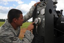 U.S. Air Force Staff Sgt. Daniel Torres, 823rd RED HORSE Squadron electrical power production supervisor from Hurlburt Field, Fla., reads gauges on a BAK-12 after a cable engagement exercise on Seymour Johnson Air Force Base, N.C., Aug. 21, 2012. The gauges take readings of the F-15E Strike Eagle engagement on the pendant cable and determines how much impact the cable endured. (U.S. Air Force photo/Airman 1st Class John Nieves Camacho/Released)