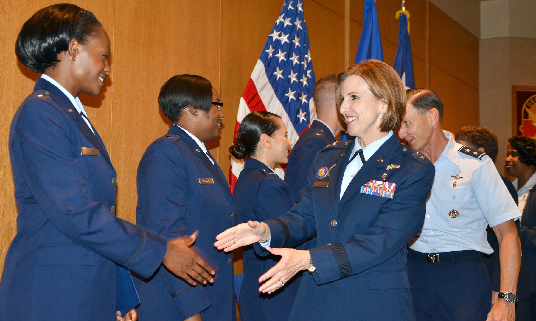 Maj. Gen. Kimberly A. Siniscalchi, assistant Air Force surgeon general, Medical Force Development, Nursing Services, shakes hands with 2nd Lt. Stephanie Lord (left), one of the 12 Air Force Nursing Residency Program graduates following their graduation ceremony Aug. 20 at the San Antonio Military Medical Center. (Photo by Lori Newman, JBSA-Fort Sam Houston Public Affairs)