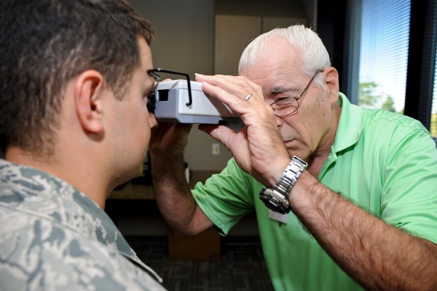 Dale Taylor, 92nd Aerospace Medicine Squadron optometry technician, measures the distance between pupils for fitting glasses properly on patient Senior Airman Ilya Demchuk, 92nd Civil Engineer Squadron heating, ventilation, air conditioning and refrigeration technician, in the base optometry clinic at Fairchild Air Force Base, Wash., Aug. 22, 2012. Optometry exams are available to U.S. servicemembers annually as part of the health care service they are provided. (U.S. Air Force photo by Senior Airman Benjamin Stratton)