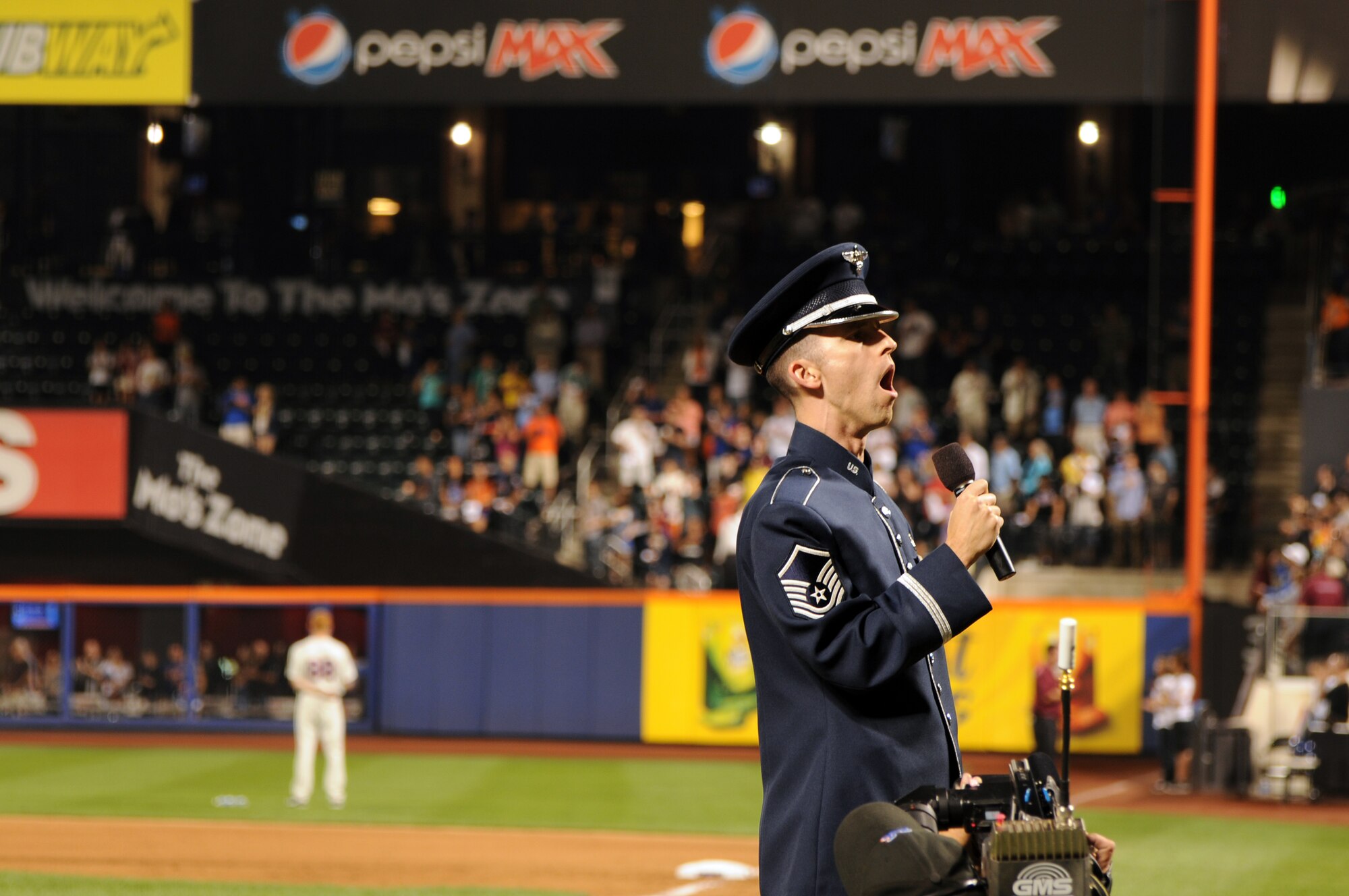 Master Sgt. Mathew Irish, U.S. Air Force Band vocalist, sings "God Bless America" Aug. 20 at Citi Field, Queens, N.Y. Irish and The Ceremonial Brass ensemble opened for the New York Mets during Air Force Week. (U.S. Air Force photo by Senior Airman Tabitha N. Haynes)
