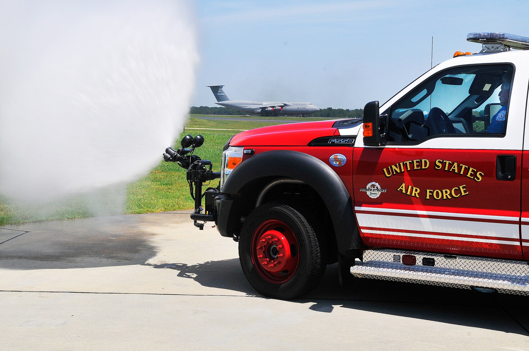 Rusty Adams demonstrates the new P-34 Rapid Intervention Vehicle that uses new ultra-high-pressure firefighting technology. It produces a smaller water droplet allowing the use of less water and more effectively knocking down fires.The smaller trucks are more maneuverable and  for the specific purpose of being the first on the scene. (U. S. Air Force photo/Sue Sapp)