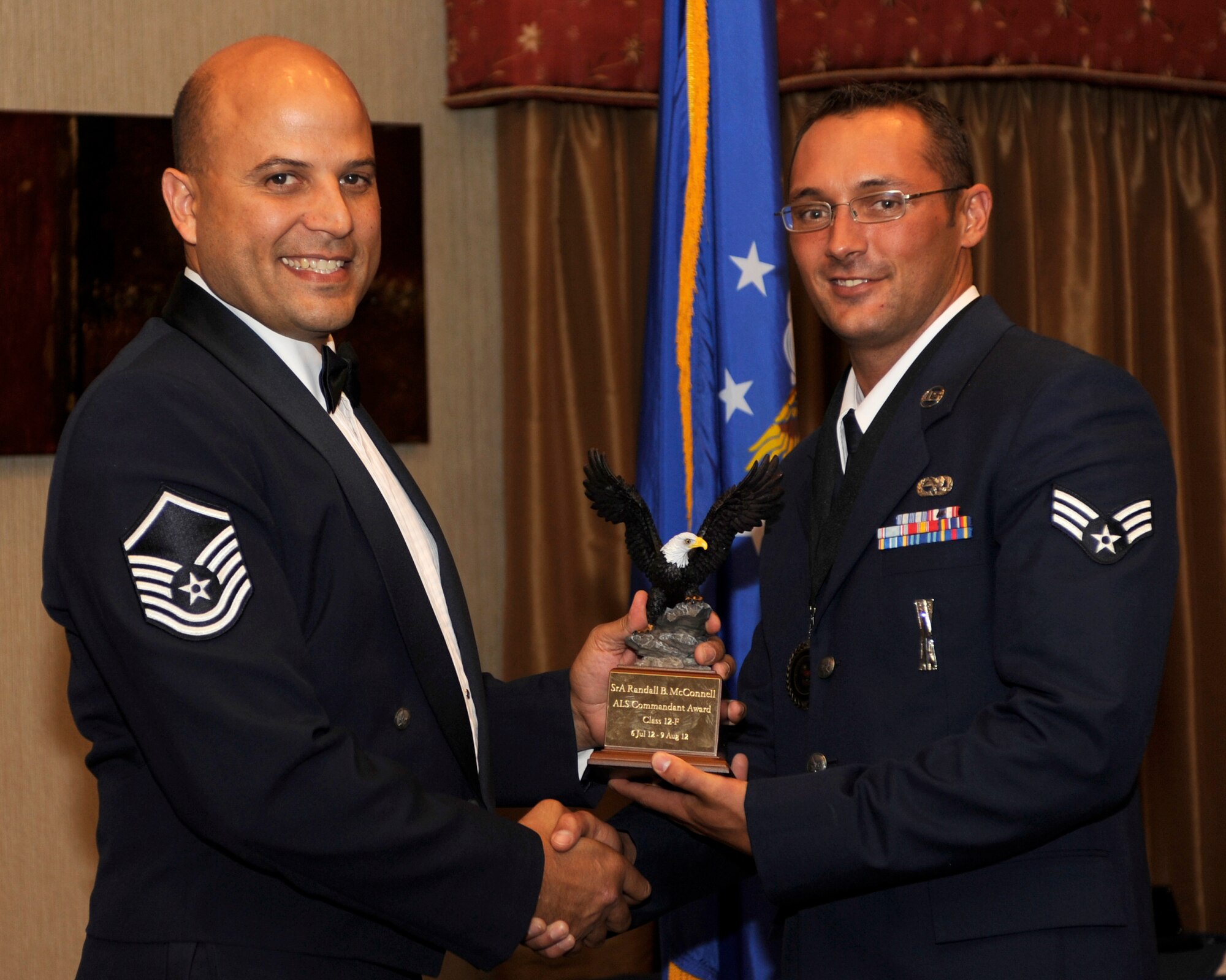 MINOT AIR FORCE BASE, N.D. -- Senior Airman Cody McConnell, 5th Aircraft Maintenance Squadron standardization load crew member,  is presented with the Airman Leadership School Commandant Award for successfully completing the training program. Mcconnell recently graduated from ALS and shared his experience about the importance of undergoing this training. ALS is a five-week program eligible Senior Airmen go through in preparation for ascension to the rank of a Junior Non-commissioned Officer. (U.S. Air Force photo/Airman 1st Class Stephanie Ashley)