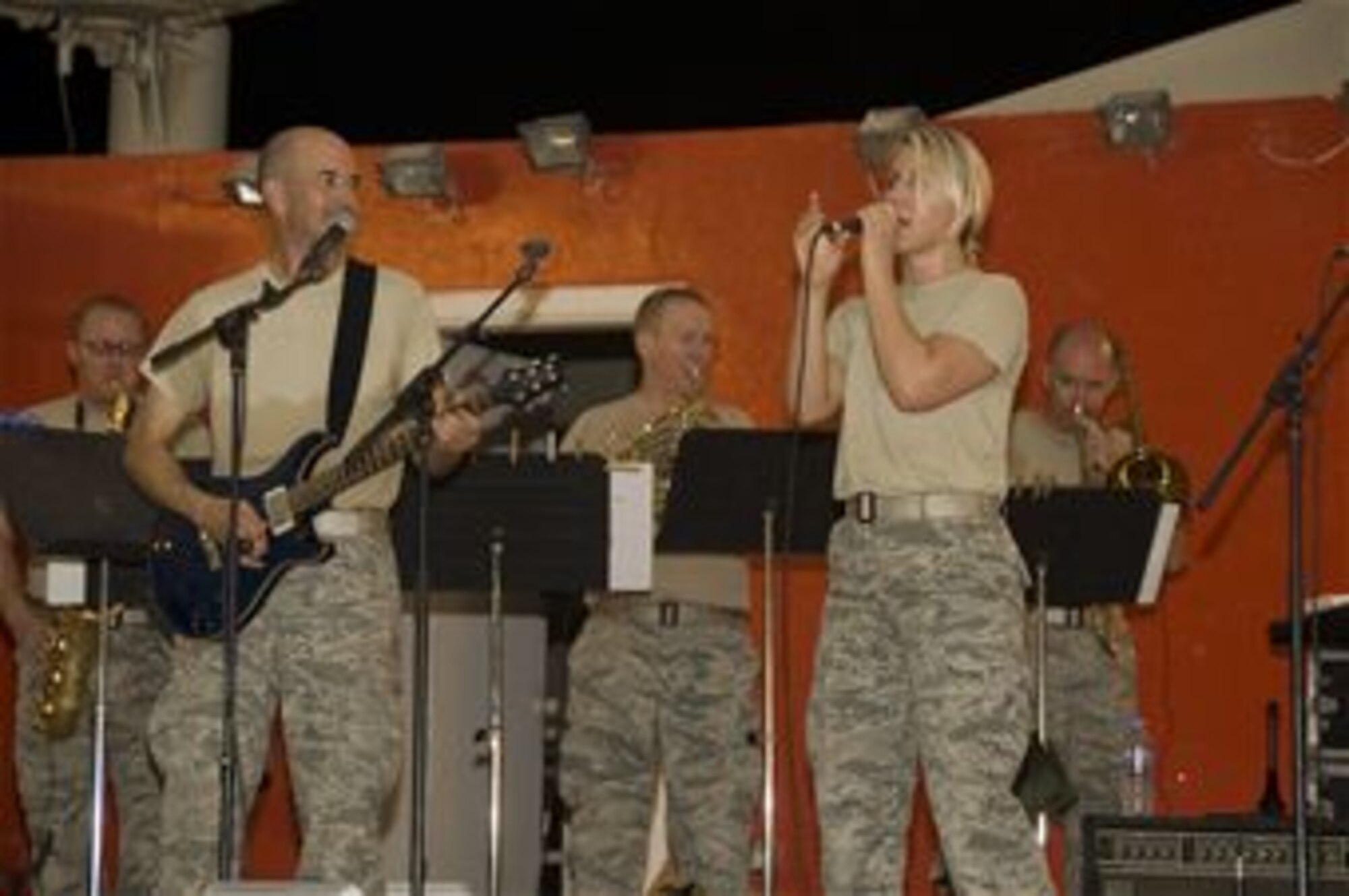 Senior Airman Jamie Horner caught the eye of the Air Force Central Band’s director of operations after singing in the finals of the 379th Force Support Flight singing competition, "The Voice." Horner began singing with the band during local performances due to their lack of a female vocalist. The Redding, Calif., native is deployed from Joint Base Andrews, Md., and is a 379th Expeditionary Civil Engineer Squadron emergency manager. (U.S. Air Force photo/Senior Airman Bryan Swink)
