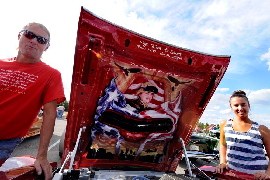 MINOT AIR FORCE BASE, N.D. -- Dana Peterson, a rancher from Ryder, N.D. and his daughter Amanda, pose with a portrait of U.S. Army National Guard Sergeant Keith L. Smette's, featured on the underside hood of Peterson's 1970 Ford Torino during the 7th Annual Show and Shine here Aug. 17. The portrait was done in memory of Smette who lost his life in Iraq when his humvee was struck by an improvised explosive device. Smette was part of the 957th Engineering Company based out of Bismarck, N.D. (U.S Air Force photo/Airman 1st Class Stephanie Ashley)