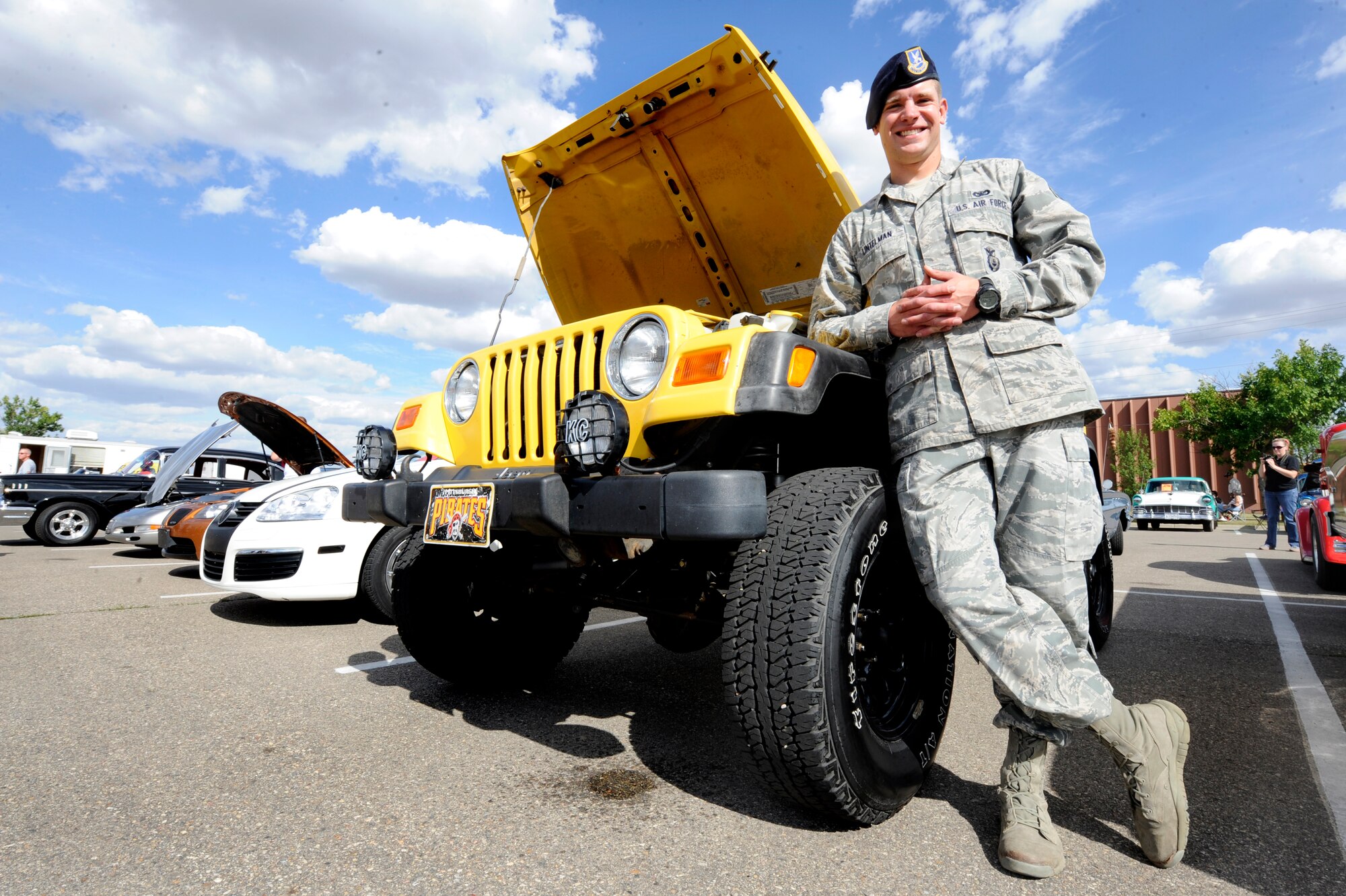 MINOT AIR FORCE BASE, N.D. - Senior Airman Andrew Lintelman, 91st Security Forces Group tactical response force assaulter, poses with his Jeep Wrangler Sport at the 7th Annual Show and Shine here Aug. 17. The Jeep featured a 4.0 straight six cylinder engine and four inch suspension lifts. Lintelman plans on adding 33 and a-half by 12-inch mud tires in the future. (U.S Air Force photo/Airman 1st Class Stephanie Ashley)