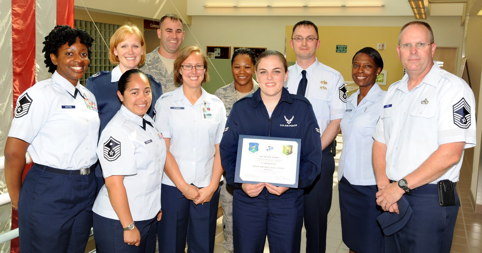 MINOT AIR FORCE BASE, N.D. - Airman 1st Class Jenny Lowe, 5th Medical Operations Squadron public health technician, receives an award from the Minot Top 3 for her excellence in performing day-to-day operations here Aug. 20. Part of her duties include processing records reviews for overseas, retraining, special duty, flying class physicals and commissioning programs among other duties. Recently, Lowe manned a 3-person duty section by herself while completing over 100 clearances within a 24-hour span. (U.S. Air Force photo/Airman 1st Class Andrew Crawford)