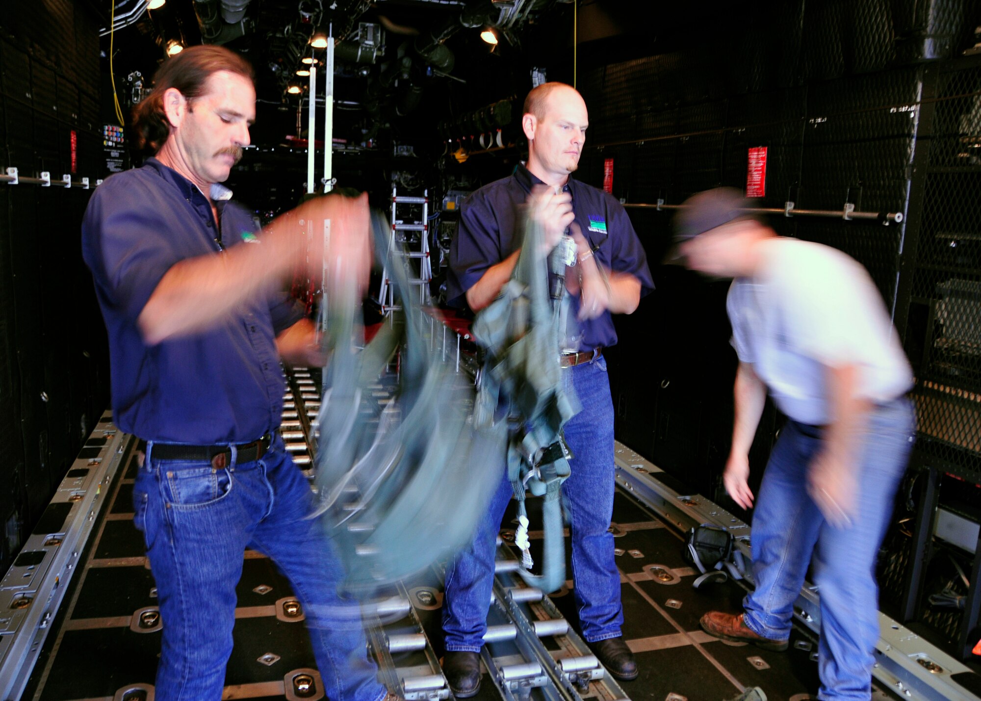 From left, Chris Barre and Richard Hinnah, wildlife biologists from the U.S. Department of Agriculture, don harnesses inside a 919th Special Operations Wing MC-130E aircraft at Duke Field, Fla.  The harnesses kept them securely tethered on the aircraft’s open cargo ramp as they conducted aerial observations of wildlife habitats.  The Air Force Reserve wing supported the department’s request for an aerial photography flight to document wildlife habitats that can create potential aviation hazards, such as bird strikes, at Duke Field and Eglin Air Force Base, Fla. (U.S. Air Force photo/Dan Neely)