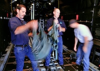 From left, Chris Barre and Richard Hinnah, wildlife biologists from the U.S. Department of Agriculture, don harnesses inside a 919th Special Operations Wing MC-130E aircraft at Duke Field, Fla.  The harnesses kept them securely tethered on the aircraft’s open cargo ramp as they conducted aerial observations of wildlife habitats.  The Air Force Reserve wing supported the department’s request for an aerial photography flight to document wildlife habitats that can create potential aviation hazards, such as bird strikes, at Duke Field and Eglin Air Force Base, Fla. (U.S. Air Force photo/Dan Neely)