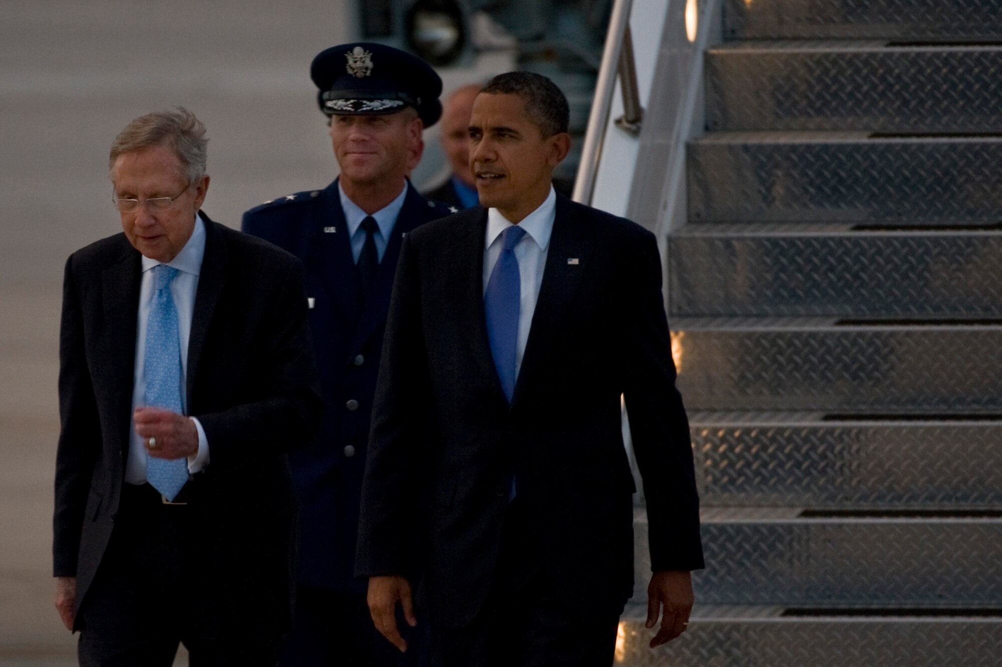 President Barack Obama and Sen. Harry Reid D-Nev., are escorted by Maj. Gen. Jeffrey Lofgren, U.S. Air Force Warfare Center commander, upon arrival Aug. 21, 2012, at Nellis Air Force Base, Nev. The president is scheduled to discuss education and spending with members of the Las Vegas local community. (U.S. Air Force photo by Airman 1st Class Daniel Hughes)
