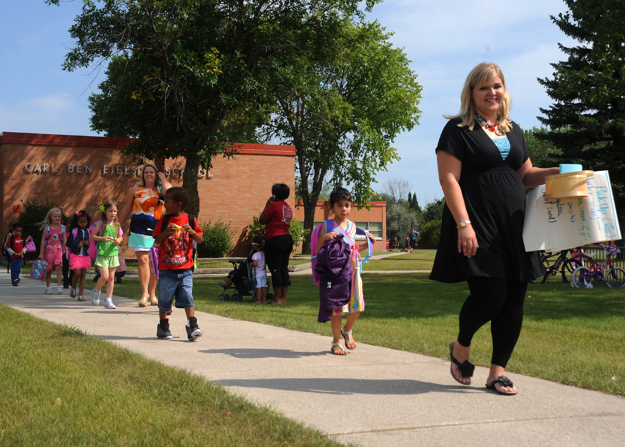 Teachers from Carl Ben Eielson Elementary School escort students to their buses after their first day of school Aug.22, 2012, on Grand Forks Air Force Base, N.D.   Approximately 600 military-affiliated students of the Grand Forks community went back to school this week.  (U.S. Air Force photo/Airman 1st Class Xavier Navarro)