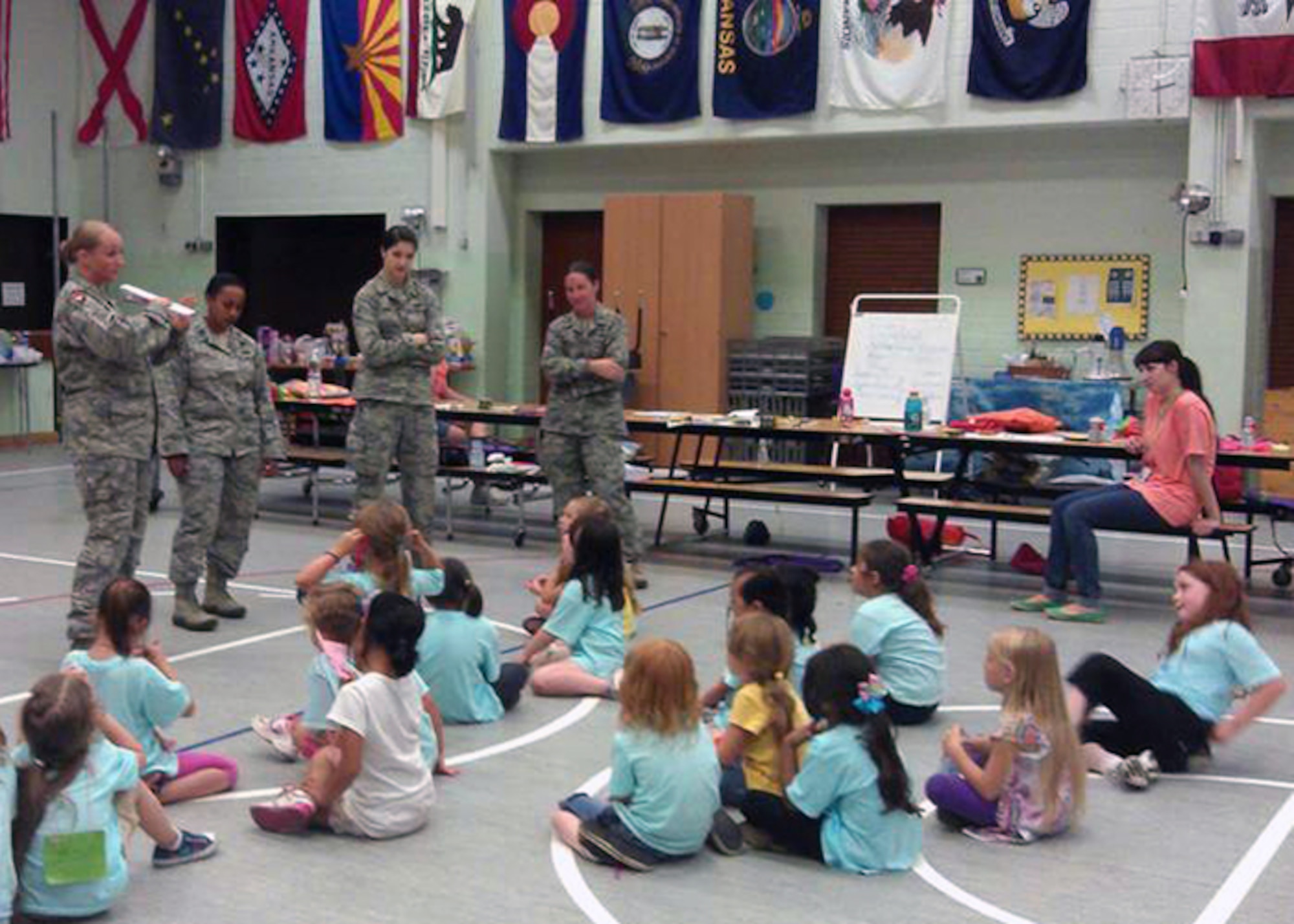 SPANGDAHLEM AIR BASE, Germany – From right to left, Police Officer Melanie Bryant, Capt. Lidia Iyassu, Airman 1st Class Paige Shaw and Capt. Julie Roloson, 52nd Security Forces Squadron, teach Girl Scouts from USA Girl Scouts Overseas at the Spangdahlem Elementary School here Aug. 21 during a summer camp. The Girl Scouts partnered with the 52nd SFS to learn techniques in identifying and reacting to strangers, basic defensive striking techniques, and strategies for getting attention during an emergency. (U.S. Air Force photo by Tech. Sgt. Jose De Jesus/Released)