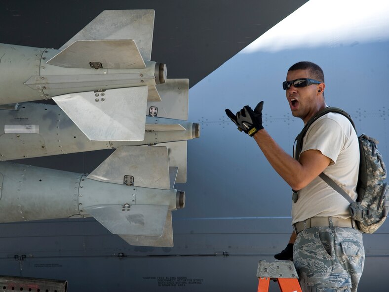 Senior Airman Matthew Wallace, Global Strike Challenge nuclear/conventional load crew team member, shouts instructions to the jammer operator during a dry run leading up to the 2012 Air Force Global Strike Command Challenge on Barksdale Air Force Base, La., Aug. 20. Wallace is part of a four-person load crew that will compete against load crews from other AFGSC bases, as well as the Air National Guard, Air Force Reserve Command and Air Combat Command during the weapons load portion of the challenge next week.  (U.S. Air Force photo/Staff Sgt. Chad Warren)(RELEASED)