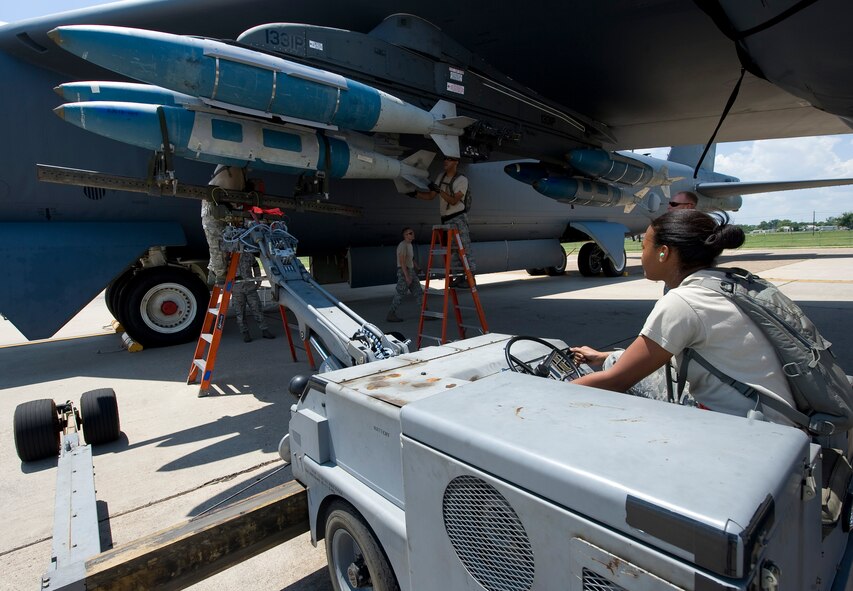 Members of the Global Strike Challenge nuclear/conventional load crew team lift a GBU-31 Joint Direct Attack Munition into position during a dry run leading up to the 2012 Air Force Global Strike Command Challenge on Barksdale Air Force Base, La., Aug. 20. The annual challenge consists of a variety of competitions based around bomber and missile operations, allowing Airmen to compete for the title of best in Air Force Global Strike Command, as well as the Air National Guard, Air Force Reserve Command and Air Combat Command. (U.S. Air Force photo/Staff Sgt. Chad Warren)(RELEASED)