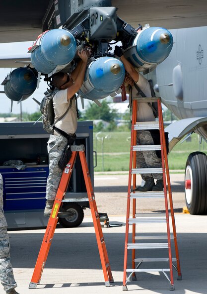 Senior Airman Matthew Wallace and Tech. Sgt. Ryan Asaria, Global Strike Challenge nuclear/conventional load crew team members, attach a GBU-31 Joint Direct Attack Munition to the wing of a B-52H Stratofortress during a dry run leading up to the 2012 Air Force Global Strike Command Challenge on Barksdale Air Force Base, La., Aug. 20. The weapons load portion is one of several events in the competition that allows security forces, maintenance and operations Airmen the opportunity to compete for the title of best in the command.   (U.S. Air Force photo/Staff Sgt. Chad Warren)(RELEASED)