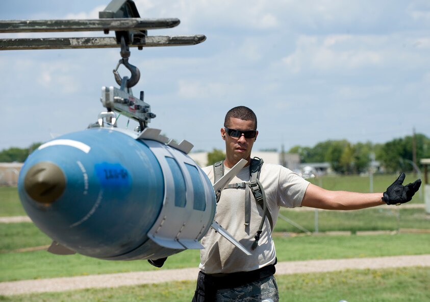 Senior Airman Matthew Wallace, Global Strike Challenge nuclear/conventional load crew team member, stabilizes a GBU-31 Joint Direct Attack Munition as it is transported to a lift during a dry run leading up to the 2012 Air Force Global Strike Command Challenge on Barksdale Air Force Base, La., Aug. 20. Wallace is part of a four-person load crew that will compete against load crews from other AFGSC bases, as well as the Air National Guard, Air Force Reserve Command and Air Combat Command during the weapons load portion of the challenge next week. (U.S. Air Force photo/Staff Sgt. Chad Warren)(RELEASED)