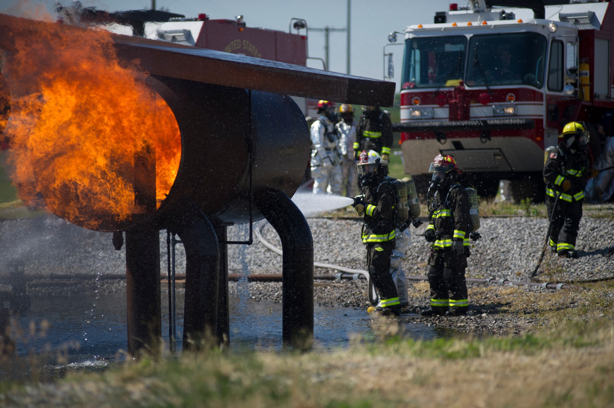 McConnell firefighters train to fight and put out multiple types of fires during an exercise July 7, 2012, McConnell Air Force Base, Kan. Training exercises ensure Airmen are ready to fight fires such as the recent fire that burned 22-acres of grassland on base. (U.S. Air Force photo/Airman 1st Class Armando A. Schwier-Morales) 