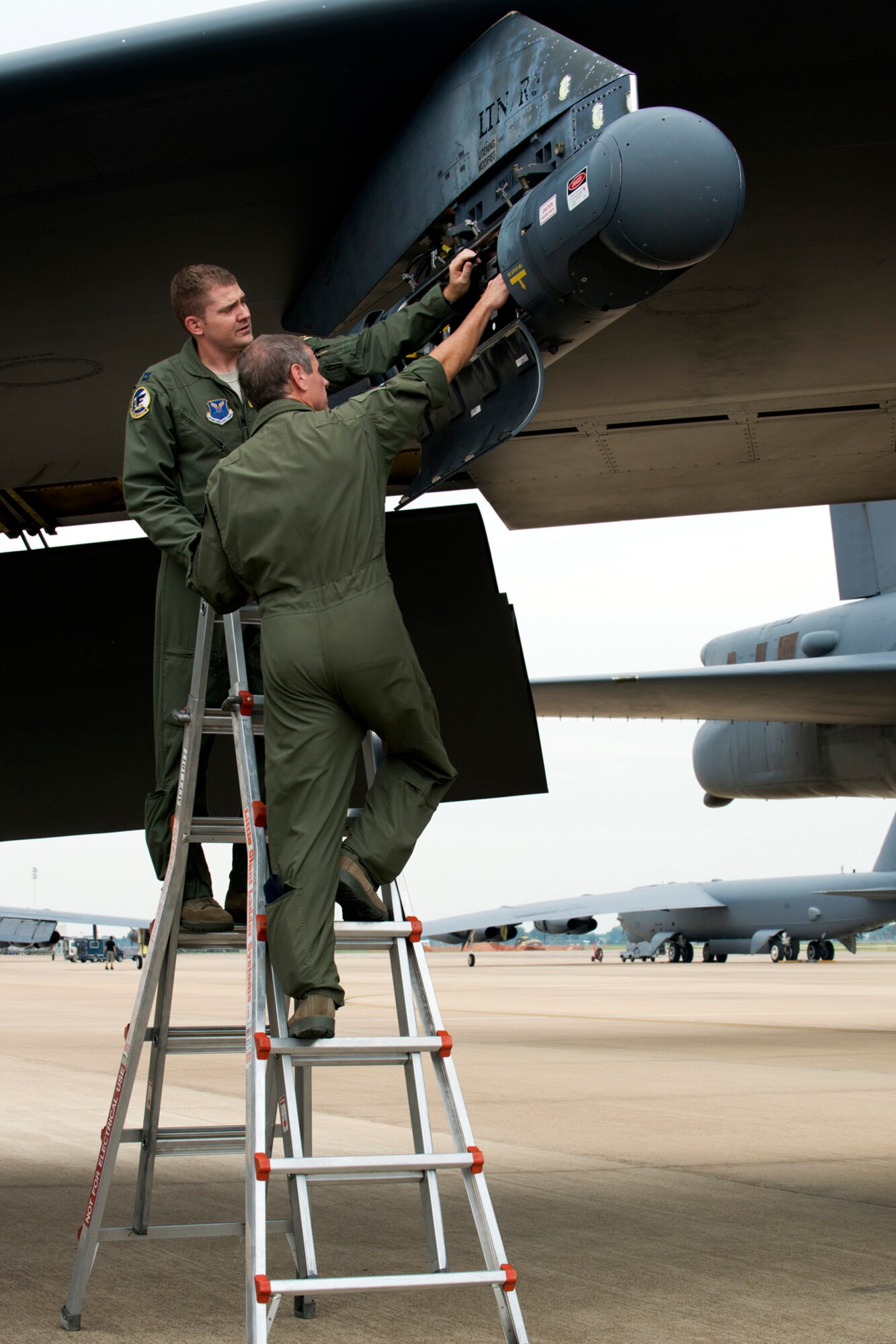 U.S. Air Force Capt. Michael Pyle and Lt. Col. Steve Smith perform a preflight inspection on a targeting pod prior to a sortie on Aug. 21, 2012, Barksdale Air Force Base, La. Smith (foreground), a B-52 radar navigator, is a member of the 93rd Bomb Squadron's Global Strike Challenge competition team. (U.S. Air Force photo by Master Sgt. Greg Steele/Released)