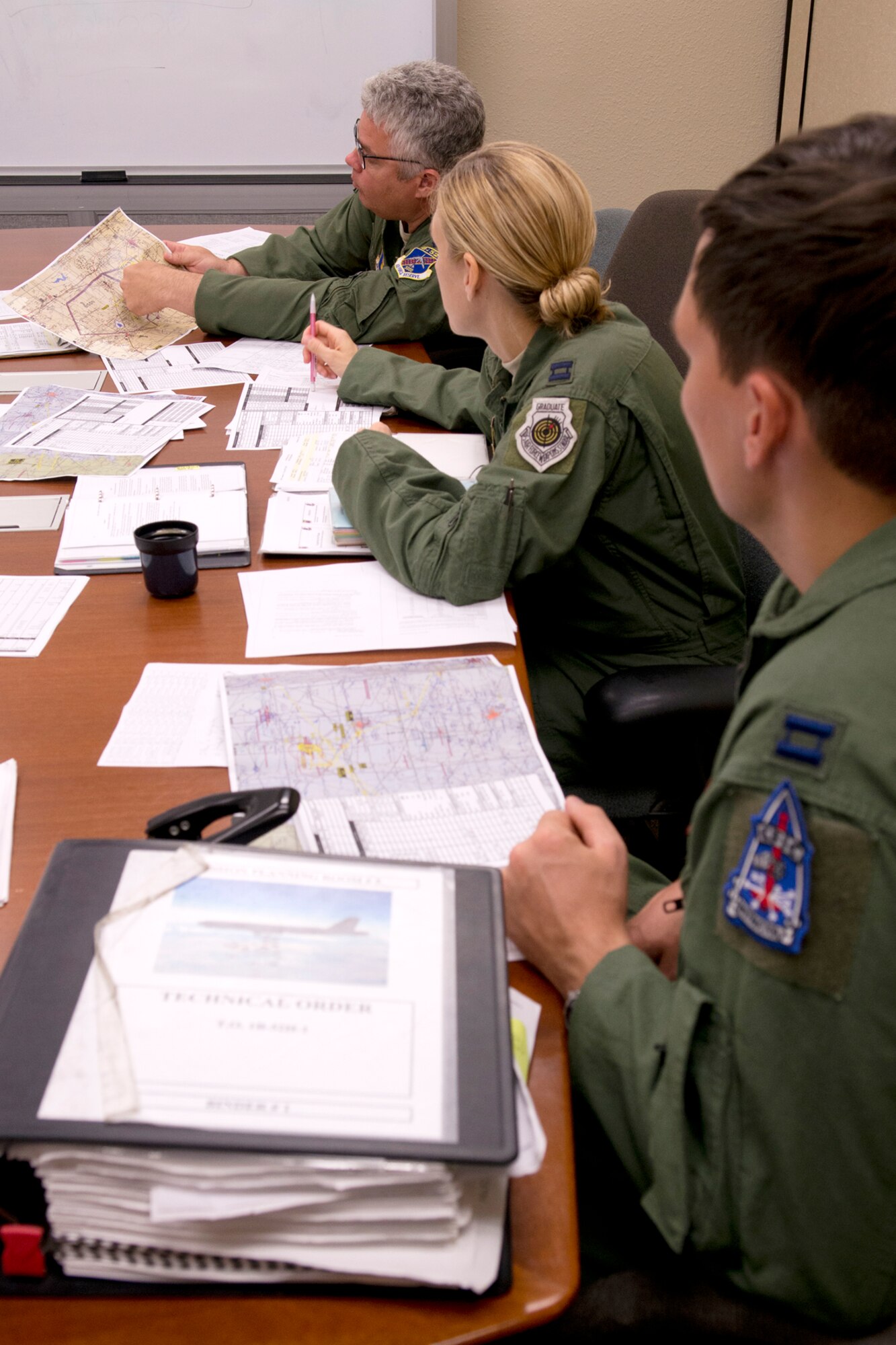 U.S. Air Force Capts. Wayne Johnson and Andrea McElvaine look on as Lt. Col. Kurt McClure goes over bombing range restrictions during a preflight briefing on Aug. 21, 2012, Barksdale Air Force Base, La. The aircrews, assigned to the 307th Bomb Wing, fly the B-52H Stratofortress and are preparing for the upcoming Global Strike Challenge competition, which will put their flying and bombing skills up against other bomber units across the U.S. (U.S. Air Force photo by Master Sgt. Greg Steele/Released)