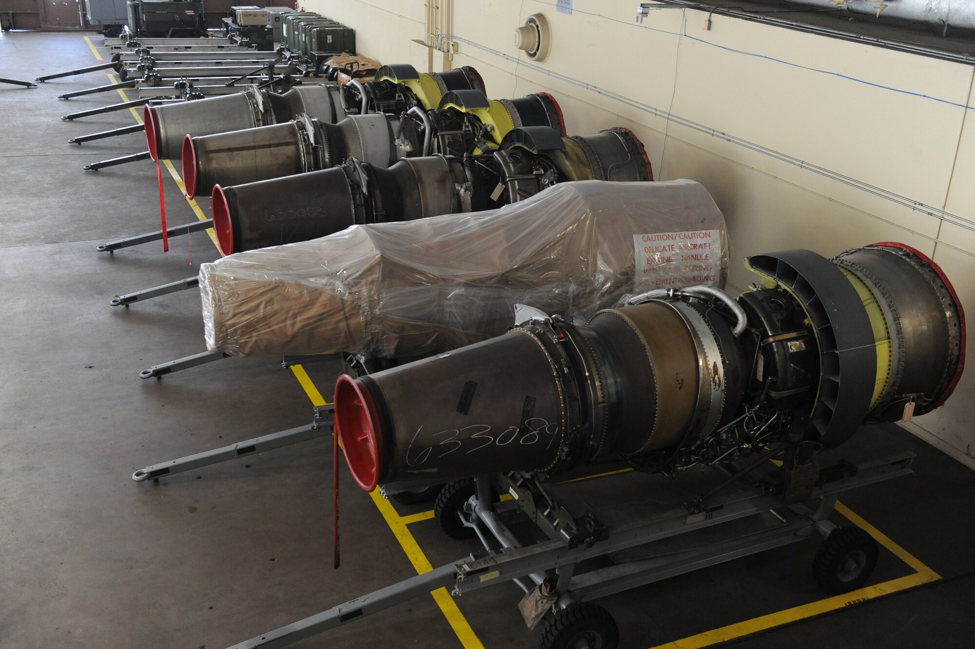 Spare B-52H Stratofortress TF33/P-103 turbofan engines sit in the 2nd Maintenance Squadron Engine Management hangar on Barksdale Air Force Base, La., Aug. 22. To protect engines during shipment, they are wrapped in paper and plastic. Engines are shipped to and from Tinker AFB, Okla., for major and scheduled maintenance. (U.S. Air Force photo/Airman 1st Class Micaiah Anthony)(RELEASED)