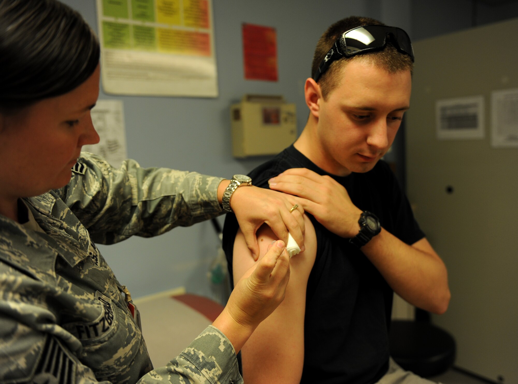 Tech. Sgt. Kammy Fitzgerald (left), 39th Medical Operations Squadron NCO in charge of allergy and immunizations section, immunizes Senior Airman Kenton Wagner, 39th Operations Squadron air traffic controller Aug. 22, 2012, at Incirlik Air Base, Turkey. The month of August is National Immunization Awareness Month, where medical professionals prepare for and inform people about the upcoming cold and flu season. Routine immunizations are important in saving lives since they prevent common but deadly diseases. (U.S. Air Force photo by Senior Airman Jarvie Z. Wallace/Released) 