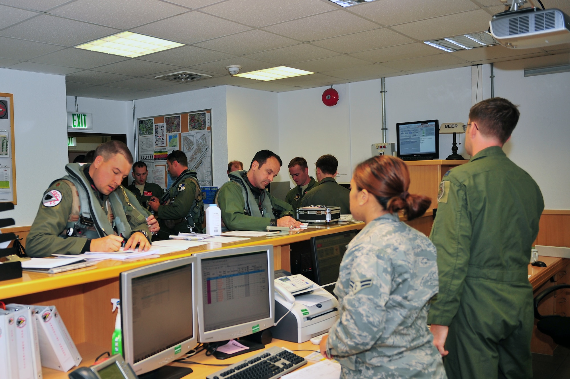 SPANGDAHLEM AIR BASE, Germany – Pilots from the 480th Fighter Squadron fill out pre-flight brief forms at the 480th FS operations desk here Aug. 23 before departing for Nordic Air Meet 2012. The fighter squadron departed for the multi-national training exercise to share and exchange new combat tactics with allied countries. (U.S. Air Force photo by Airman 1st Class Dillon Davis/Released)