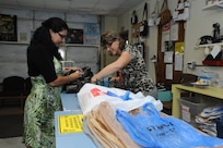 Debbie Kyrova (right), Thrift Shop volunteer, helps Susie Parsons from Air Force Personnel Center check out at the Thrift Shop on Joint Base San Antonio-Randolph, Texas, Aug. 20. Proceeds from the Thrift Shop sales goes to college scholarships for high school students. (U.S. Air Force photo by Rich McFadden) 