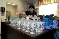 Pam Clark, Thrift Shop volunteer, arranges donated merchandise at the Thrift Shop on Joint Base San Antonio-Randolph, Texas, Aug. 20. Proceeds from the Thrift Shop sales goes to college scholarships for high school students. (U.S. Air Force photo by Rich McFadden) 