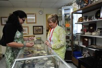 Sara Stulga (right), Thrift Shop volunteer, looks on as Susie Parson from Air Force Personnel Center finds a necklace at the thrift shop on Joint Base San Antonio-Randolph, Texas, Aug. 20. Proceeds from the Thrift Shop sales goes to college scholarships for high school students. (U.S. Air Force photo by Rich McFadden) 