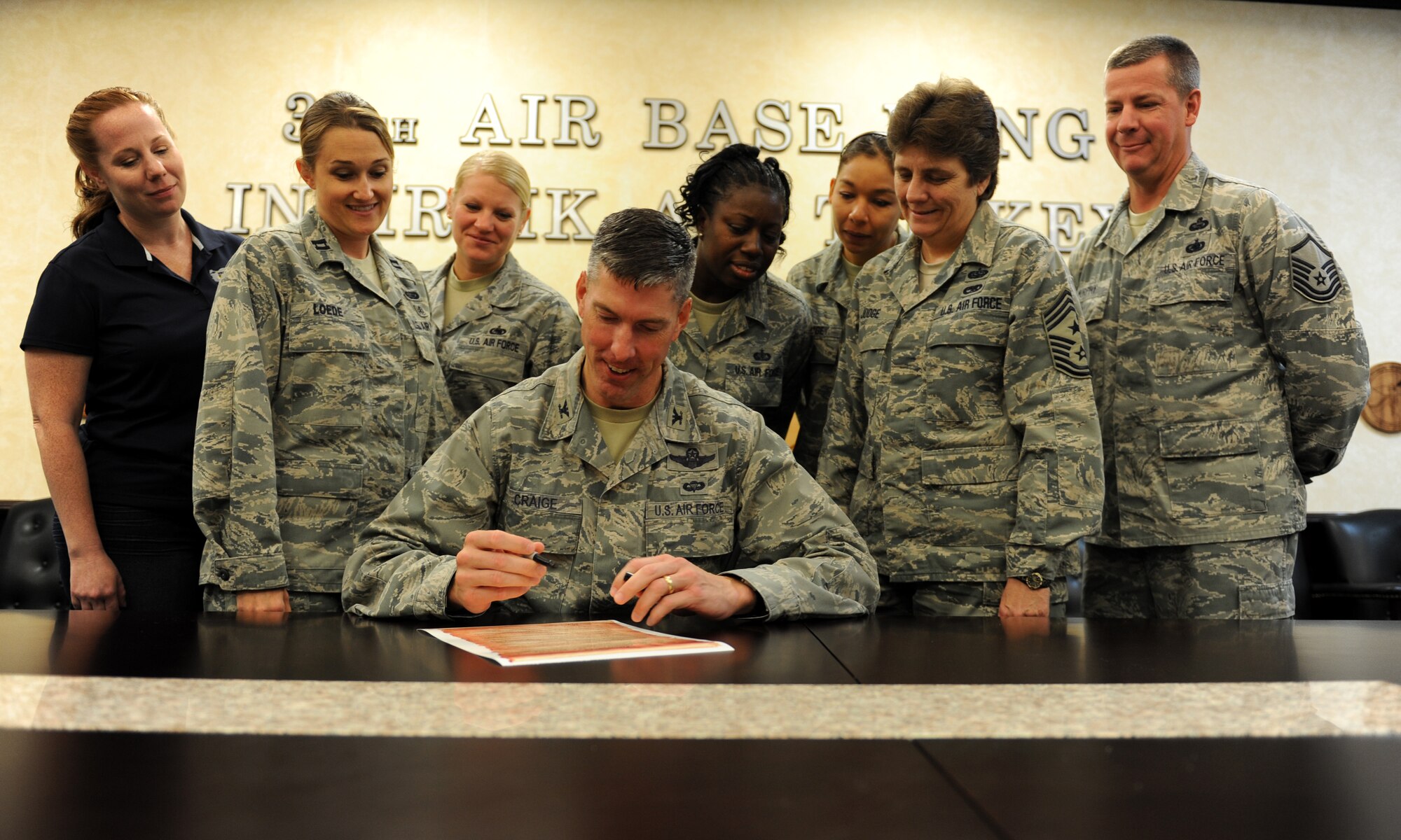 Col. Chris Craige, 39th Air Base Wing commander, signs a proclamation declaring Aug. 26 Women's Equality Day Aug. 23, 2012, at Incirlik Air Base, Turkey. In 1971, the Senate and House of Representatives of the United States assembled and resolved a Joint Resolution of Congress designating Aug. 26 of each year as Women's Equality Day. (U.S. Air Force photo by Senior Airman Jarvie Z. Wallace/Released)
