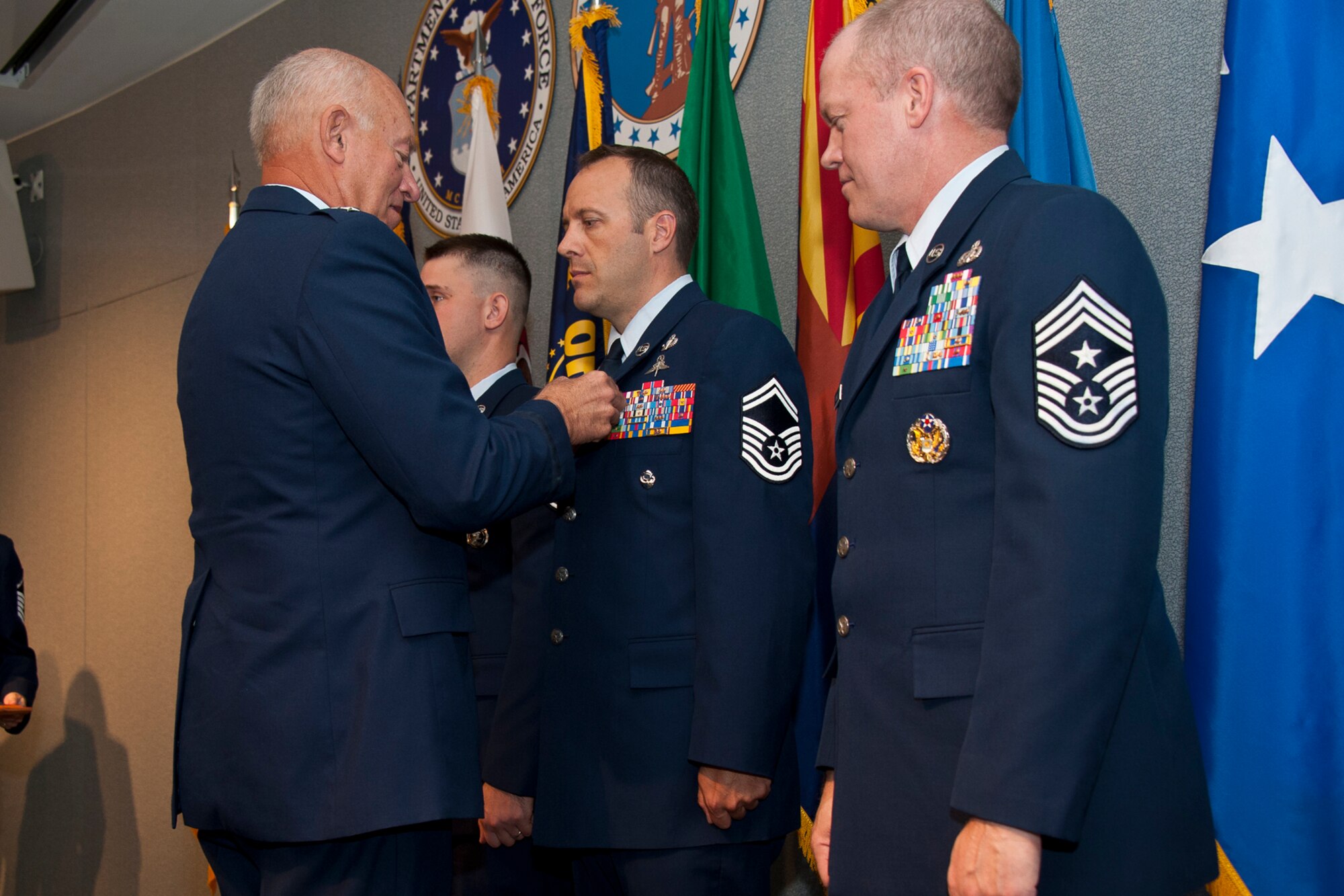 Lt. Gen. Harry M. Wyatt III, the director of the Air National Guard, and Chief Master Sgt. Christopher E. Muncy, the command chief master sergeant to the director of the ANG, present Senior Master Sgt. Luke W. Thompson, 125th Special Tactics Squadron, Oregon ANG, with the Outstanding Airman Ribbon during the 2012 ANG Outstanding Airmen of the Year awards ceremony at the Air National Guard Readiness Center, Joint Base Andrews, Md., Aug. 22, 2012. The ANG Outstanding Airmen of the Year ceremony recognizes the ANGs six top performers for superior leadership, job performance, community involvement and personal achievements. (National Guard photo by Master Sgt. Marvin Preston/RELEASED)
