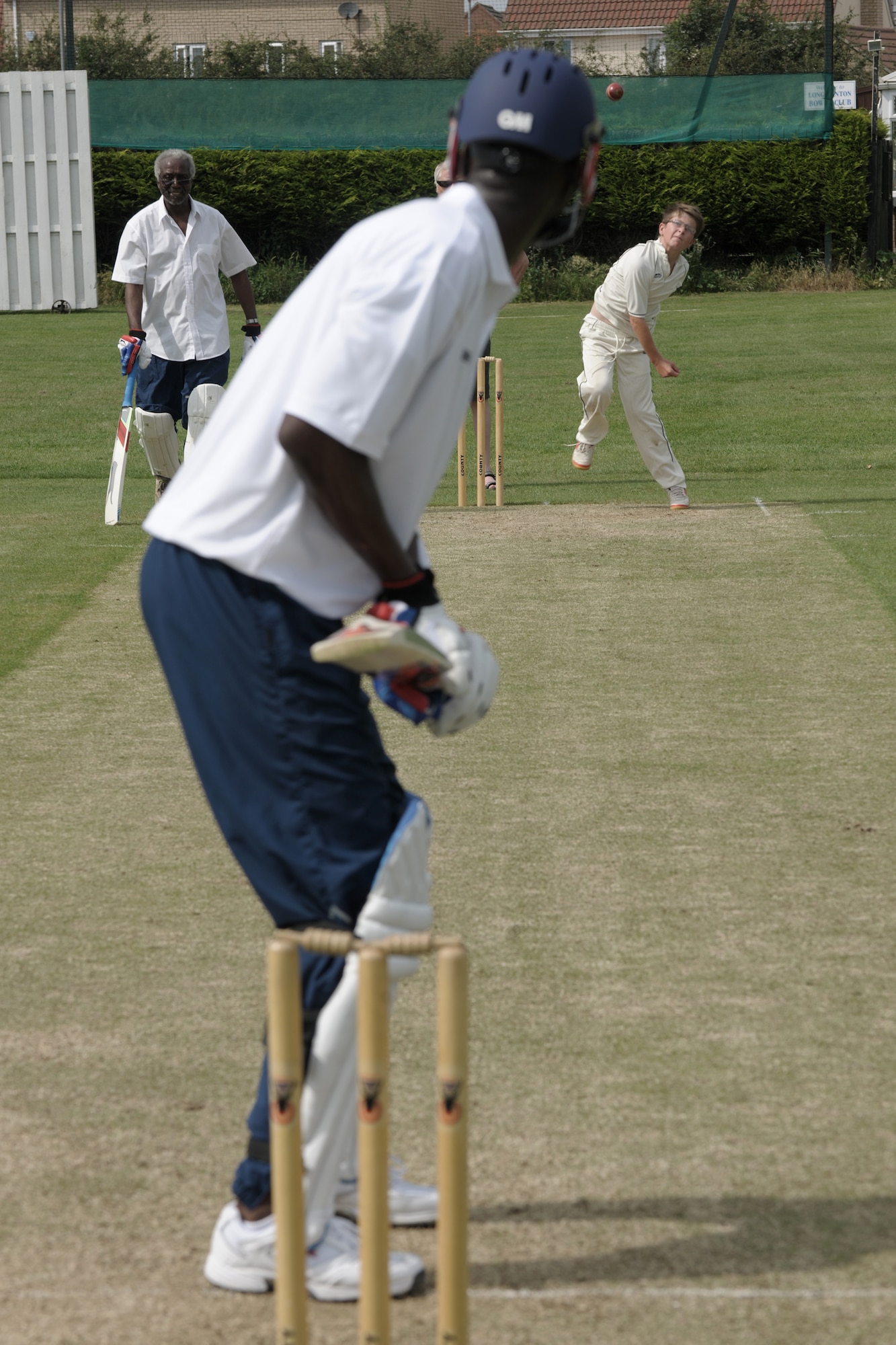 LONGSTANTON, United Kingdom – Tech. Sgt. Quami King, 423rd Medical Squadron, keeps his eyes on the ball that was bowled by the Longstanton Grasshopper during the first game played by the team Aug. 19 at Longstanton Bowls Club in Longstanton, United Kingdom. Behind each batsman is a target called a wicket. One designated member of the fielding team, the bowler, is given a ball and attempts to bowl the ball from one end of the pitch to the wicket behind the batsman on the other side of the pitch. The batsman tries to prevent the ball from hitting the wicket by striking the ball with a bat. If the bowler succeeds in hitting the wicket, or if the ball, after being struck by the batsman, is caught by the fielding team before it touches the ground, the batsman is dismissed. (U.S. Air Force photo by Master Sgt. John Barton)