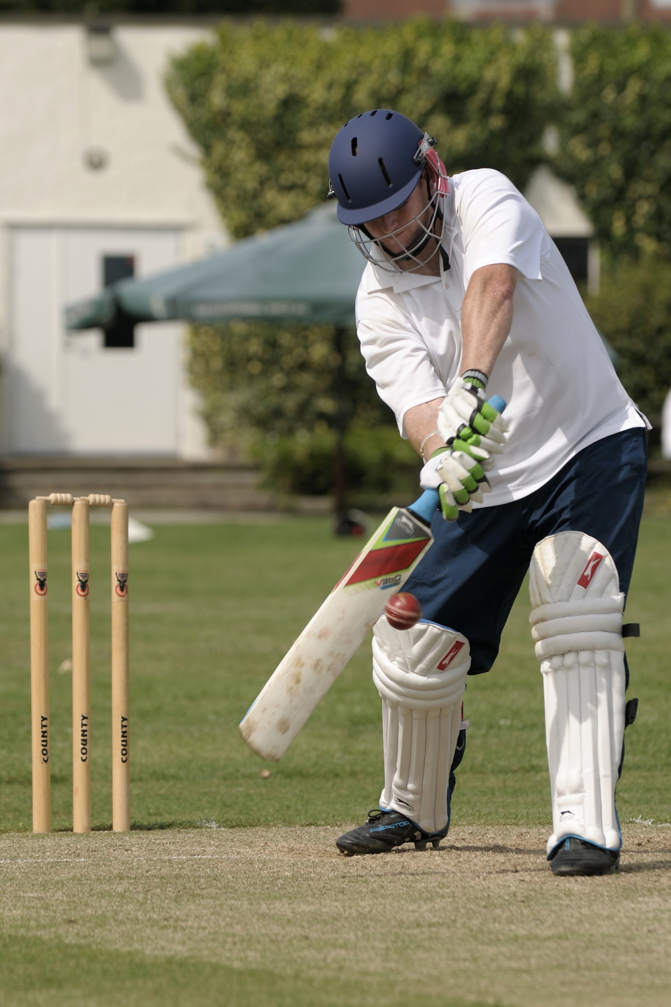 LONGSTANTON, United Kingdom – Master Sgt. Nathan Pollard, 423rd Security Forces Squadron, swings for the ball a Longstanton Grasshopper bowled during the first game played by the team Aug. 19 at Longstanton Bowls Club in Longstanton, United Kingdom. Behind each batsman is a target called a wicket. One designated member of the fielding team, the bowler, is given a ball and attempts to bowl the ball from one end of the pitch to the wicket behind the batsman on the other side of the pitch. The batsman tries to prevent the ball from hitting the wicket by striking the ball with a bat. If the bowler succeeds in hitting the wicket, or if the ball, after being struck by the batsman, is caught by the fielding team before it touches the ground, the batsman is dismissed. (U.S. Air Force photo by Master Sgt. John Barton)