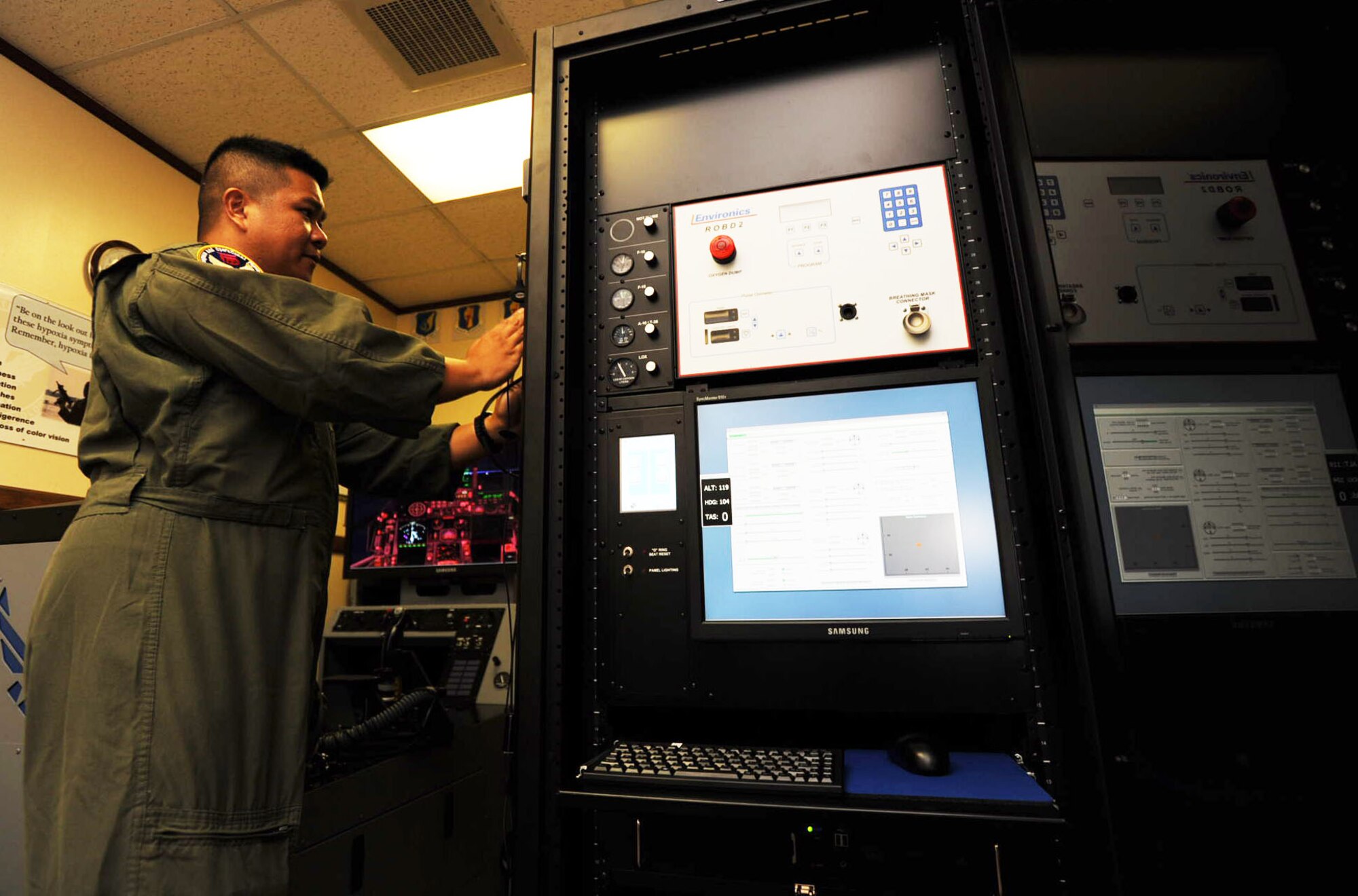 U.S. Air Force Capt. Joseph Teodoro, 35th Aerospace Medicine Squadron aerospace and operational physiologist, sets up the Reduced Oxygen Breathing Device version two at Misawa Air Base, Japan, Aug. 21, 2012. The X-Plane 9.0 and ROBD 2, which are the two pieces of the hypoxia familiarization trainer, were brought to the base two weeks ago. The ROBD 2 is the main part of the HFT that instructors use to create a hypoxic environment for pilots who are training. (U.S. Air Force photo by Airman 1st Class Kenna Jackson/Released)