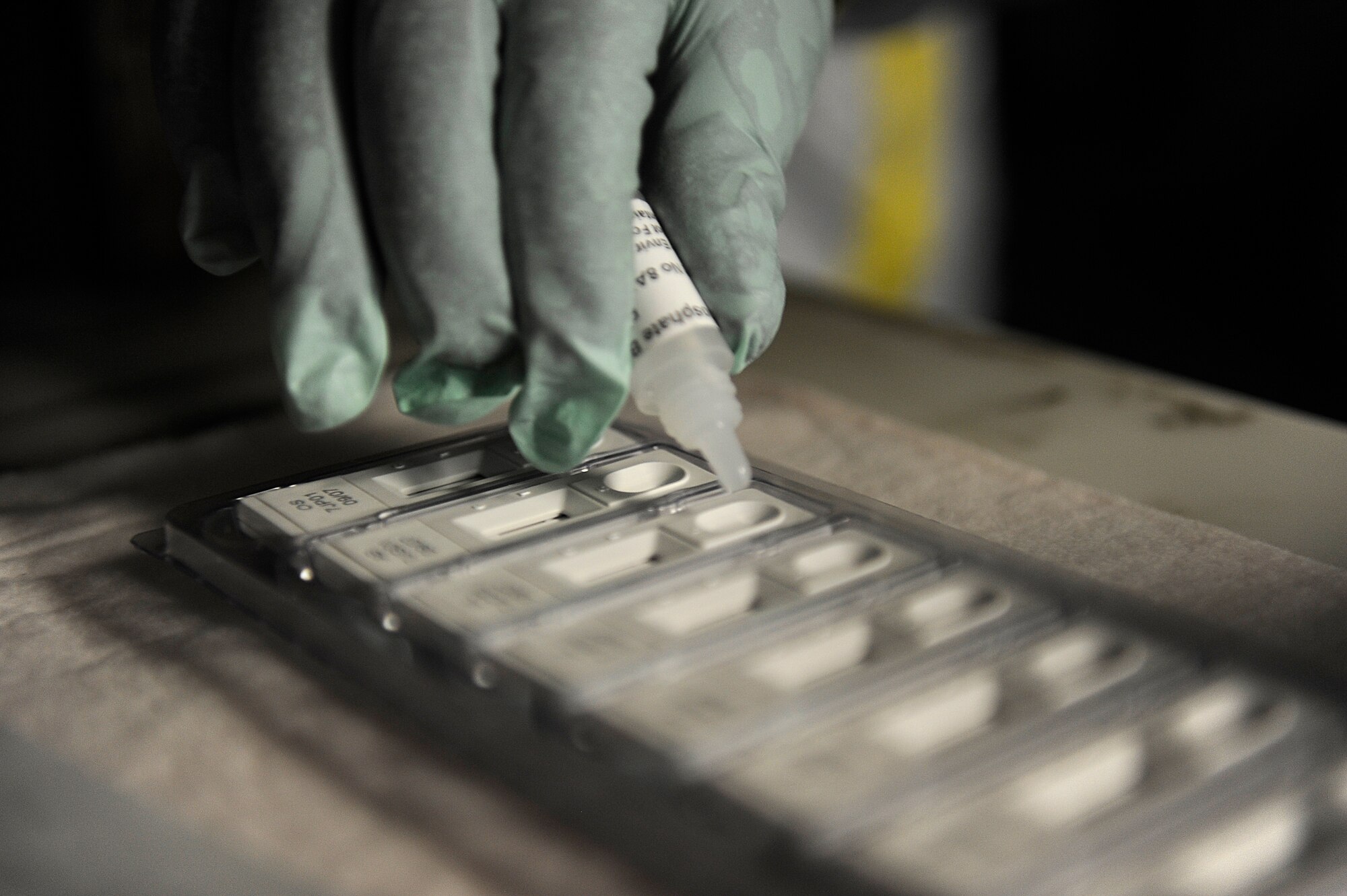A U.S. Air Force Airman from the 18th Aerospace Medicine Squadron's Bioenvironmental Engineering Flight fills a substance detection tray with a test chemical to identify an unknown substance during an emergency management exercise as part of Beverly High 12-5, a local operational readiness exercise on Kadena Air Base, Japan, Aug. 22, 2012. The EME tested Kadena Airmen's ability to respond, properly contain and decontaminate a possible anthrax threat on the base.  (U.S. Air Force photo/Senior Airman Maeson L. Elleman)