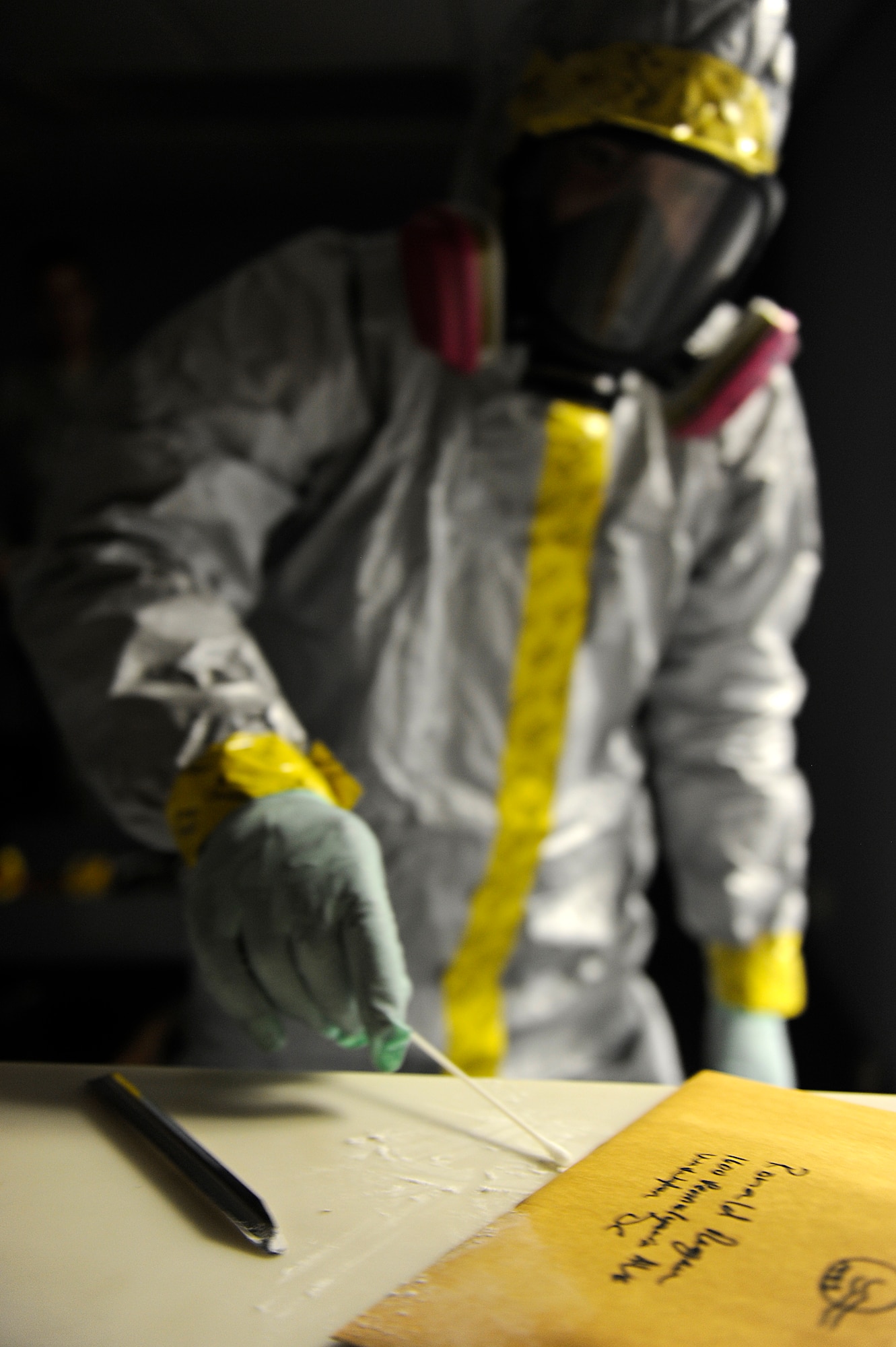 A U.S. Air Force Airman from the 18th Aerospace Medicine Squadron's Bioenvironmental Engineering Flight swabs a sample of an unknown substance found in a letter addressed to a former president during an emergency management exercise as part of Beverly High 12-5, a local operational readiness exercise on Kadena Air Base, Japan, Aug. 22, 2012. Kadena's Airmen use LOREs to test themselves in the ability to survive and operate under various conditions in order to prepare them for future contingencies. (U.S. Air Force photo/Senior Airman Maeson L. Elleman)